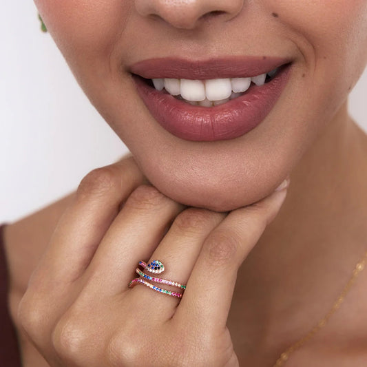 Close-up of a woman's hand with a ring, featuring a neutral background