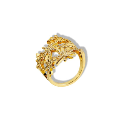 Gold ring with intricate design on a white background