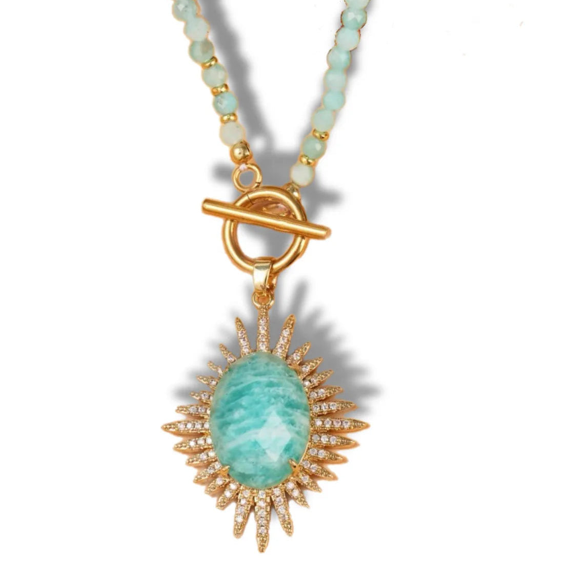Necklace with a green pendant and gold accents on a white background