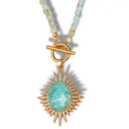 Necklace with a green pendant and gold accents on a white background