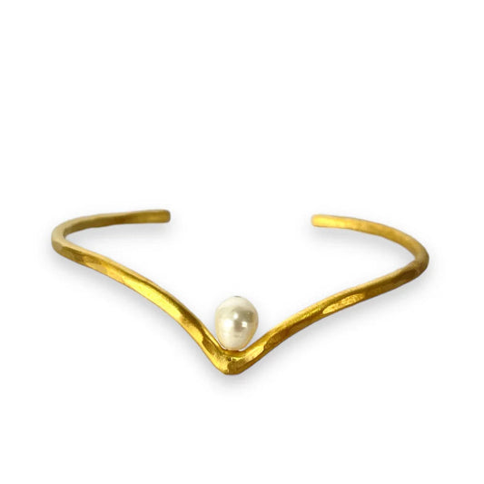 Gold bracelet with a pearl on a white background