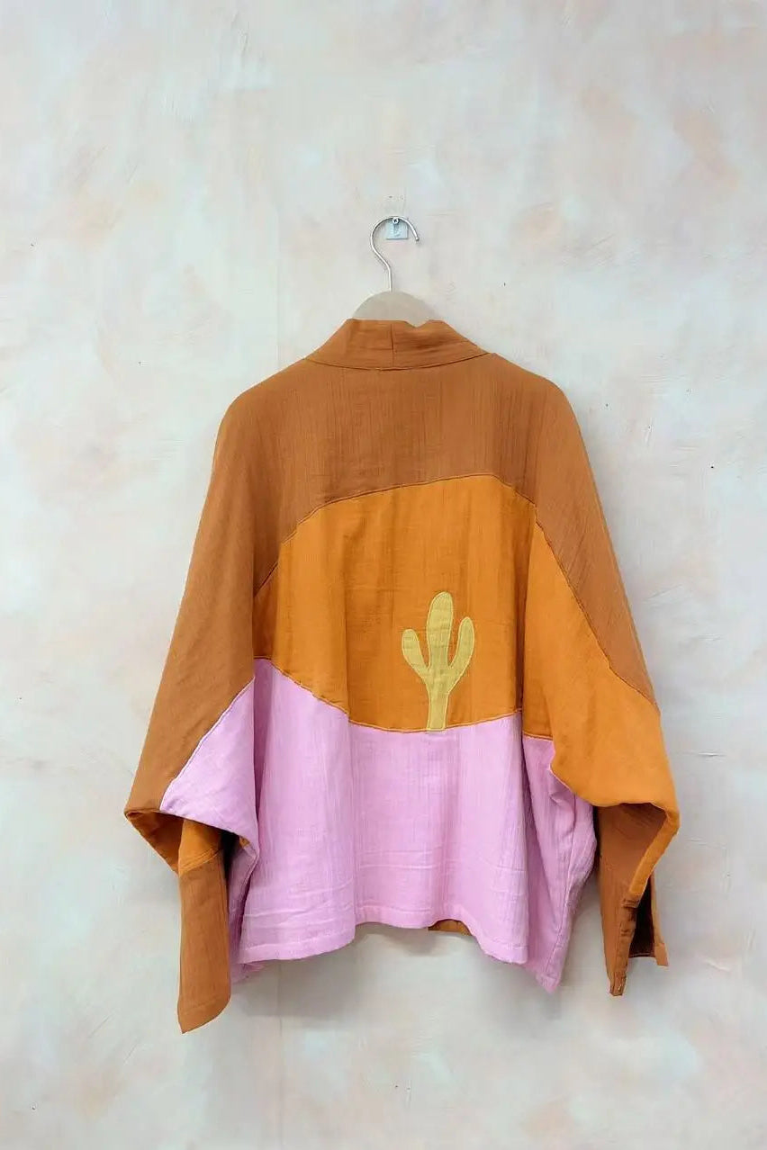 Color-blocked jacket with a cactus design on a beige background